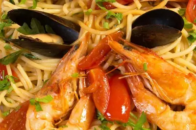 a plate of food with shrimp and pasta at Hotel Club Central in Hisarya
