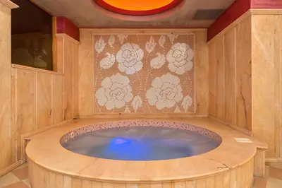 a jacuzzi tub in a room with a wall at Hotel Club Central in Hisarya