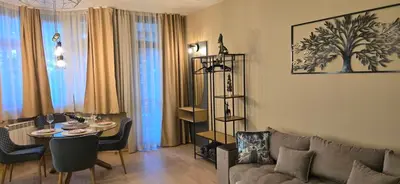 a living room with a couch and a table at Persey Flora Apartments in Borovets
