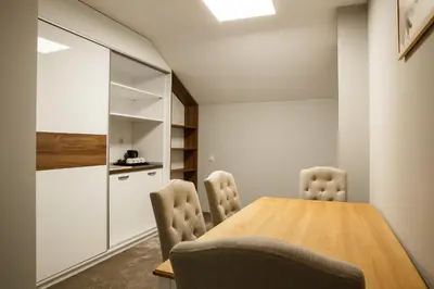 a dining room with a wooden table and chairs at Hotel Casa Karina Bansko - Half Board & All Inclusive in Bansko