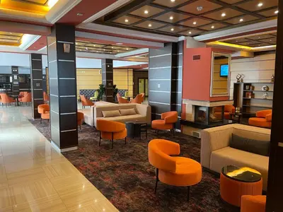 a lobby with couches and chairs in a building at Borovets Hills Ski & Spa - Half Board in Borovets