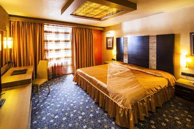 a hotel room with a bed and a desk at Hotel Anel in Sofia