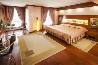 a bedroom with a bed and a desk and a table at Hotel Anel in Sofia