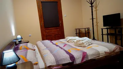 a bedroom with a bed with a blanket on it at Guest House Fun and Rest in Plovdiv