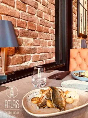 a plate of food on a table with a glass at Guest House Fun and Rest in Plovdiv