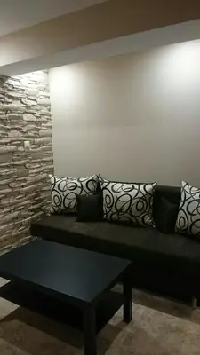 a bench in a room with pillows on a wall at Guesthouse Dida in Sapareva Banya
