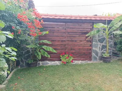 a wooden fence with flowers in a yard at Guesthouse Dida in Sapareva Banya