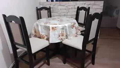 a dining room table with a white table cloth on it at Guesthouse Dida in Sapareva Banya