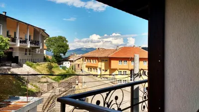 a view of a city from a balcony at Family hotel Valchanovata Kashta in Fotinovo