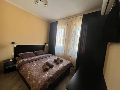 a bedroom with a bed with two shoes on it at Guesthouse Zornitsa in Hisarya