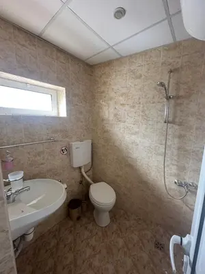 a bathroom with a toilet and a sink and a shower at Guesthouse Zornitsa in Hisarya