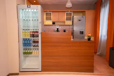 a refrigerator filled with lots of drinks in a kitchen at Guest house Traikovi in Petrich