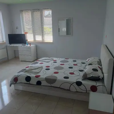 a bedroom with a bed and a desk at Viktoria House in Sapareva Banya