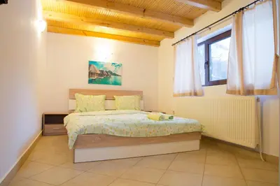 a bedroom with a bed and a window at Guest House Ivan in Cherni Osŭm