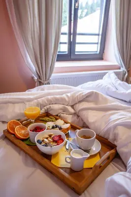 a tray of breakfast foods on a bed at Kutsinska House in Progled