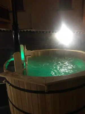 a hot tub in a barrel with a light at Kutsinska House in Progled