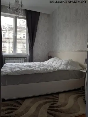 a bed in a bedroom with a window at Presidency House Self Check-in Apartments in Sofia