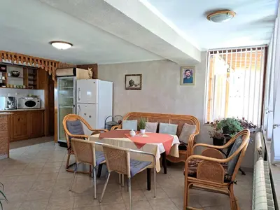 a kitchen and a dining room with a table and chairs at Guest House Benita in Devin