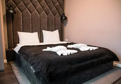 a bedroom with a bed with three towels on it at Holiday Apartment 7 in Hisarya