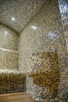 a bathroom with a toilet and tiled walls at Holiday Apartment 7 in Hisarya