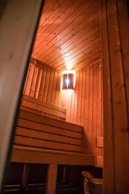 a bench in a room with a light on the wall at Holiday Apartment 7 in Hisarya
