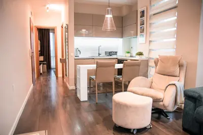 a kitchen and living room with a table and chairs at Holiday Apartment 7 in Hisarya