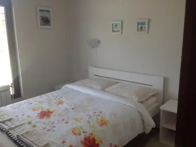 a bedroom with a bed with a floral bedspread at Mountain View Vacation Home in Balabanska