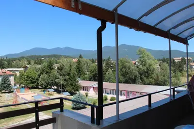 a view from the balcony of a school with mountains in the background at Panorama Apartment in Velingrad