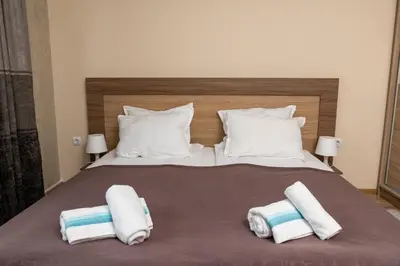 a bedroom with a bed with towels on it at Panorama Apartment in Velingrad