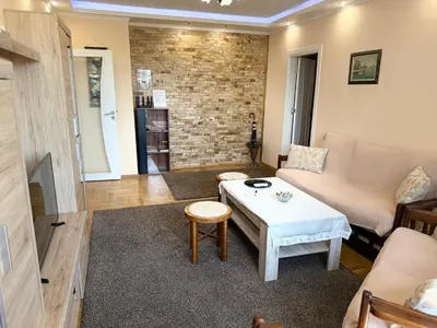 a living room with a couch and a table at Apartment Durvenitza in Sofia