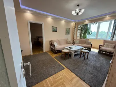 a living room with a couch and a table at Apartment Durvenitza in Sofia