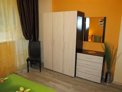 a bedroom with a dresser and a large cabinet at Apartments Vasil Levski in Plovdiv