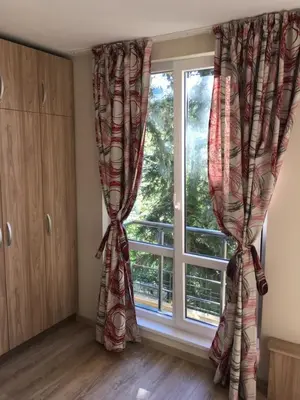 a room with a window with curtains in front of it at Park View Studios in Sandanski