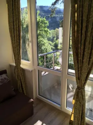 a living room with a large window with a view at Park View Studios in Sandanski