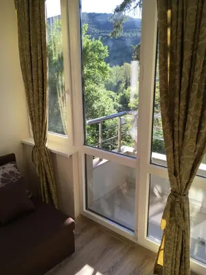 a living room with a large window with a view at Park View Studios in Sandanski