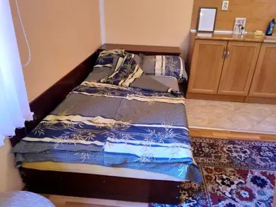 a small bedroom with a bed in the corner at Villa Vanessa Koprivki Area in Tsar Kaloyan