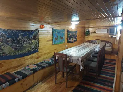 a dining room with a long table and chairs at Villa Vanessa Koprivki Area in Tsar Kaloyan