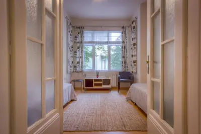 a room with two beds and a window at Guest house Maison 21 in Plovdiv