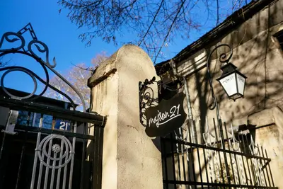 a street light on the side of a building with a gate at Guest house Maison 21 in Plovdiv