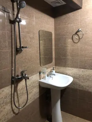 a bathroom with a sink and a shower with a mirror at House of Time in Ognyanovo