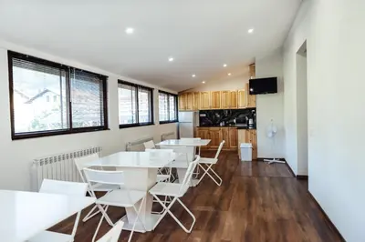 a dining room with white tables and chairs at Guesthouse Juli in Sapareva Banya