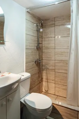 a bathroom with a toilet and a shower at Guesthouse Juli in Sapareva Banya