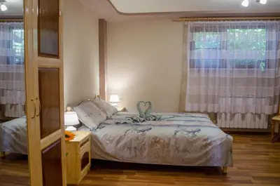 a small bedroom with a bed and a window at Guesthouse Juli in Sapareva Banya