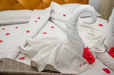 a bed with white towels and red hearts on it at Sveti Nikola Family Hotel Sapareva Banya in Sapareva Banya