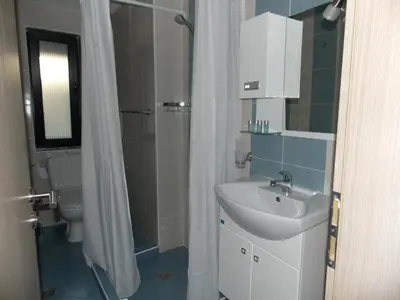 a bathroom with a sink and a shower and a toilet at Apart Hotel Rosen in Sofia