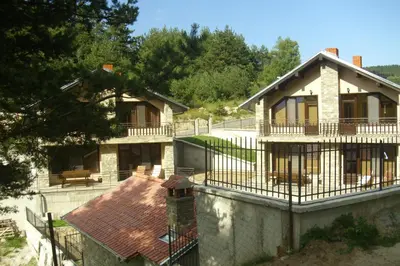 a house with a balcony and a fence at Ваканционна къща ,,Родопски уют 