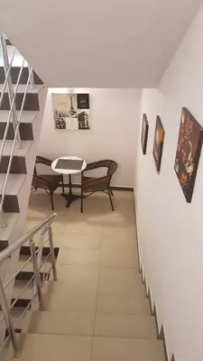 a stairway with benches and a table in a room at Central Guest Rooms in Asenovgrad