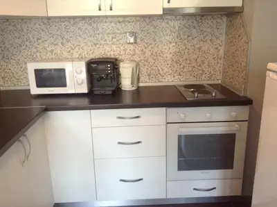 a small kitchen with a microwave and a stove at Apartment Sredetz in Sofia