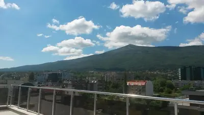 a view of a city with a mountain in the background at Apartment Sredetz in Sofia