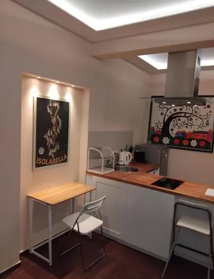 a kitchen with a counter and a table and chairs at Embassy Apartment in Sofia